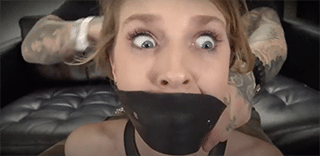 Shiny Bound – Blonde with long hair leather bound captive